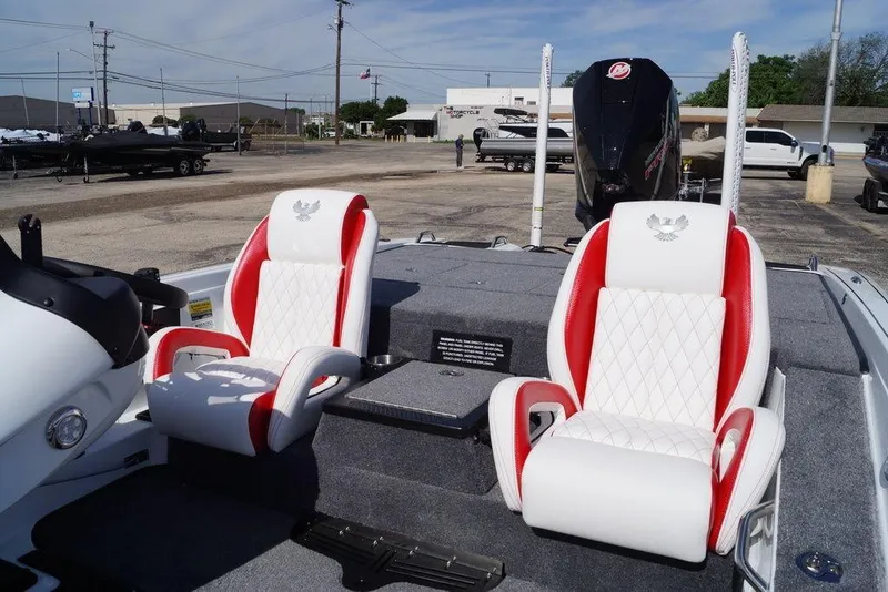 Slide: The Image of 2026 Phoenix 721 ZXL boat with red and white seats, parked outdoors. - 11