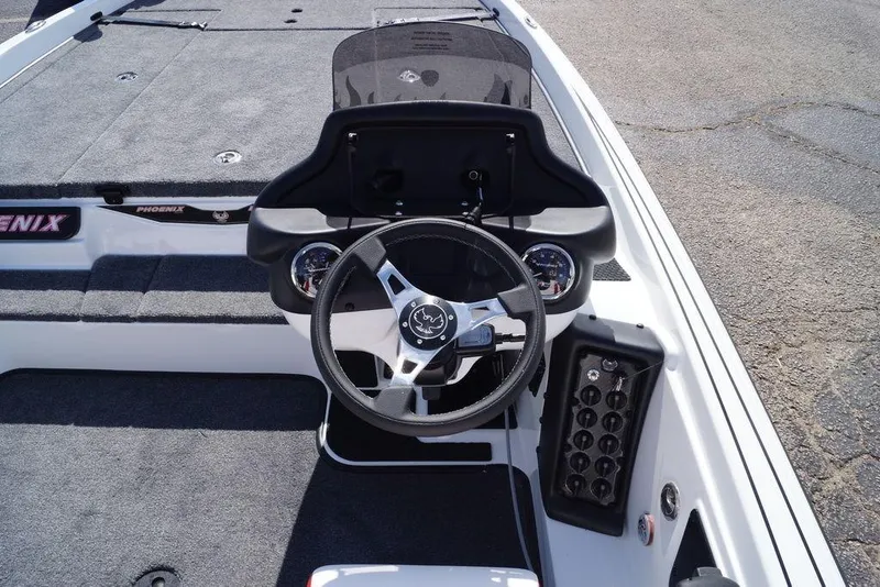 Slide: The Image of 2026 Phoenix 721 ZXL boat cockpit with steering wheel and dashboard controls. - 13