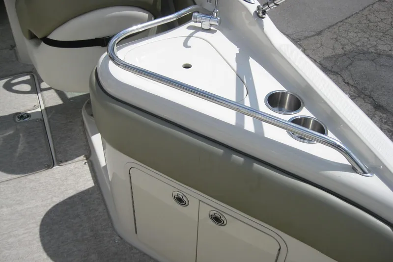 Slide: The Image of Interior view of a 2006 Sea Ray 240 Sundeck boat with cup holders and storage. - 11