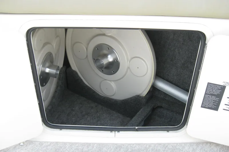 Slide: The Image of Storage compartment of a 2006 Sea Ray 240 Sundeck boat, featuring interior details. - 13