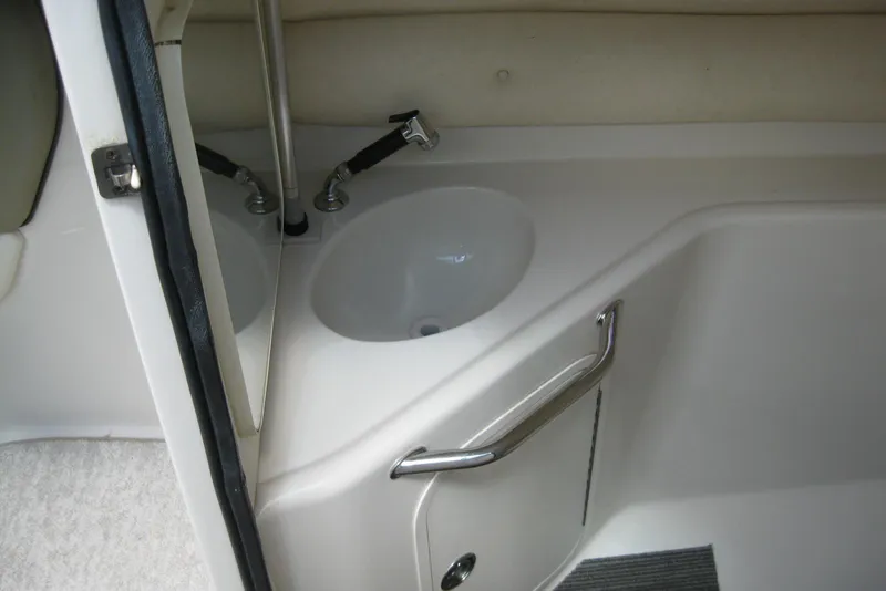 Slide: The Image of Interior view of a 2006 Sea Ray 240 Sundeck boat bathroom sink area. - 17