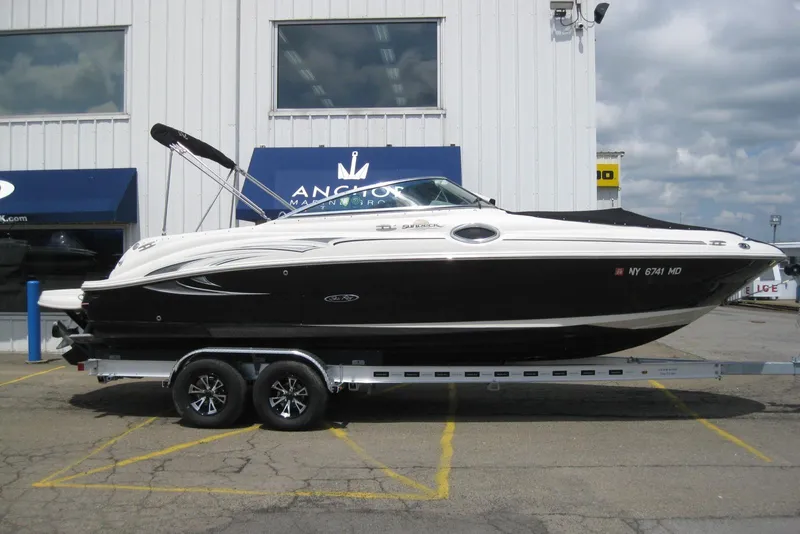 Slide: The Image of 2006 Sea Ray 240 Sundeck boat on trailer outside marine dealership. - 2