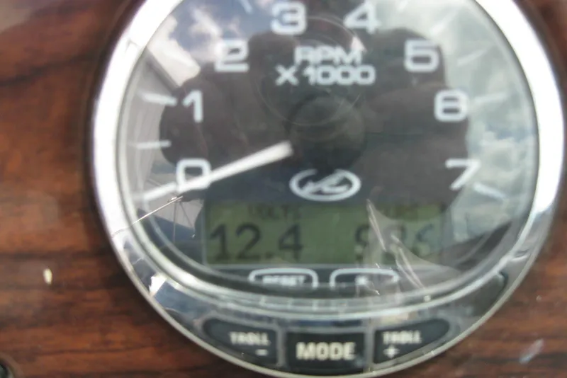 Slide: The Image of Close-up of a 2006 Sea Ray 240 Sundeck tachometer displaying RPM and digital readout. - 21