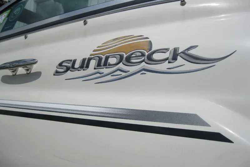 Slide: The Image of 2006 Sea Ray 240 Sundeck logo on white boat exterior. - 4