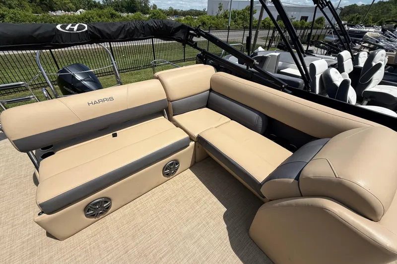 Slide: The Image of 2023 Harris Cruiser 230 pontoon boat with beige seating and integrated speakers. - 10