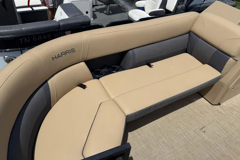 Slide: The Image of 2023 Harris Cruiser 230 boat with beige and gray seating, featuring cup holders. - 5