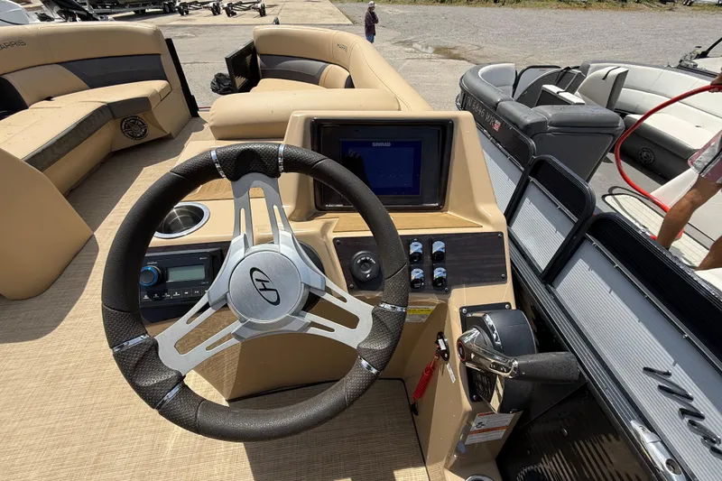 Slide: The Image of 2023 Harris Cruiser 230 boat dashboard with steering wheel and control panel. - 9