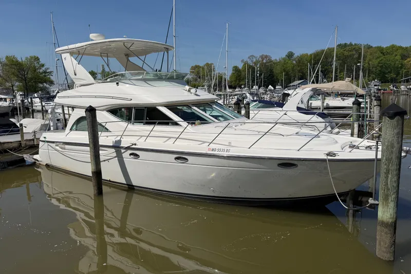 The Image of 2001 Maxum 4600 SCB Limited Edition yacht docked in a marina. - 0