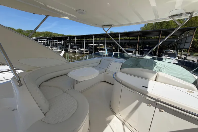 Slide: The Image of 2001 Maxum 4600 SCB Limited Edition yacht interior with seating and table, docked at marina. - 10