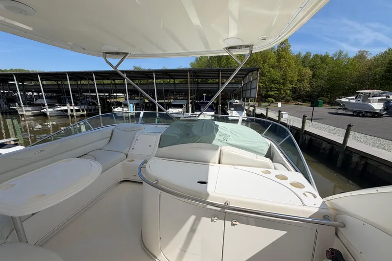 Slide: The Image of 2001 Maxum 4600 SCB Limited Edition yacht docked at marina, featuring spacious deck seating. - 11
