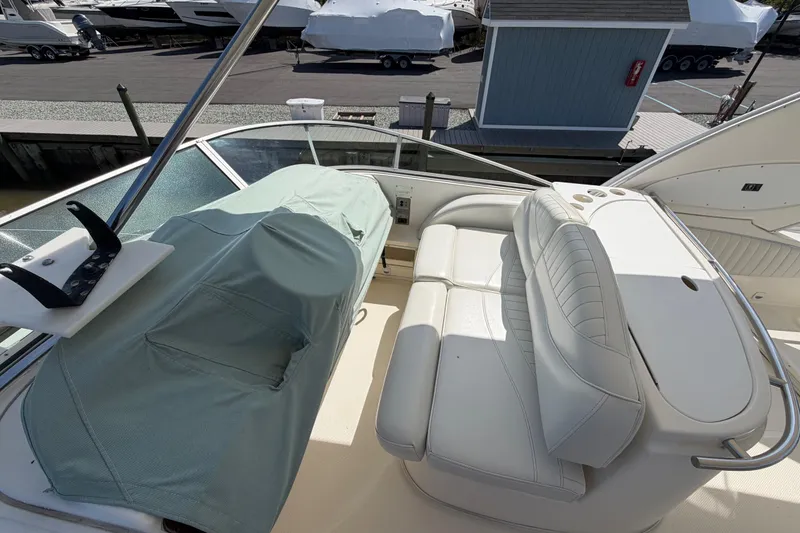 Slide: The Image of 2001 Maxum 4600 SCB Limited Edition yacht interior with white seating and covered controls. - 14