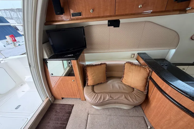Slide: The Image of Interior of 2001 Maxum 4600 SCB yacht with cozy seating and TV. - 23
