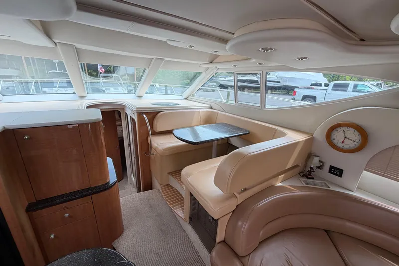 Slide: The Image of Interior of 2001 Maxum 4600 SCB yacht with beige seating and dining area. - 26