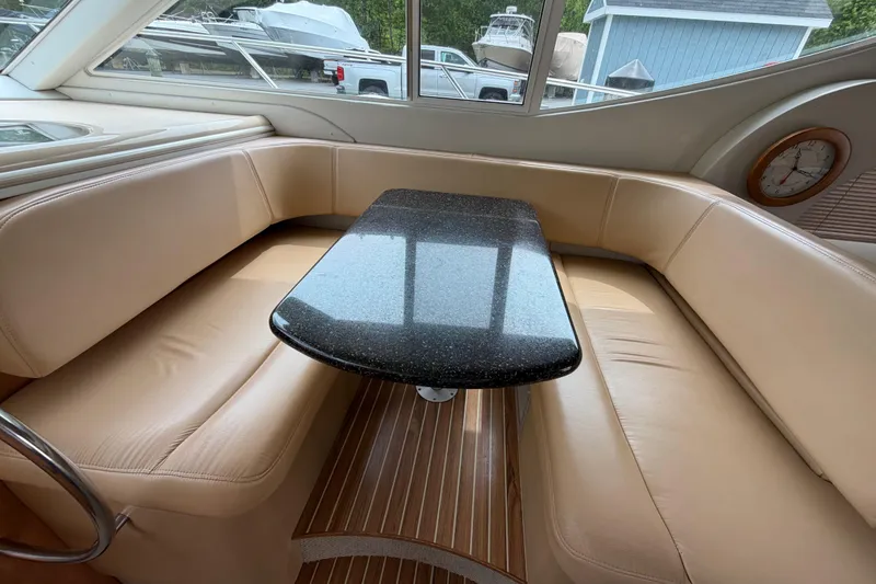 Slide: The Image of Luxurious interior of 2001 Maxum 4600 SCB yacht with beige seating and sleek black table. - 31