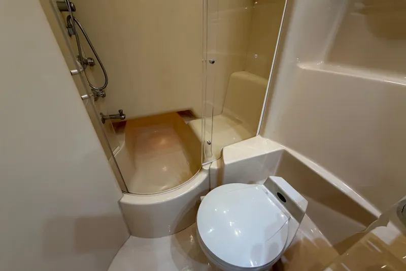 Slide: The Image of Bathroom interior of 2001 Maxum 4600 SCB Limited Edition yacht, featuring shower and toilet. - 38