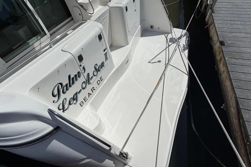 Slide: The Image of 2001 Maxum 4600 SCB Limited Edition yacht docked, featuring sleek white design. - 4