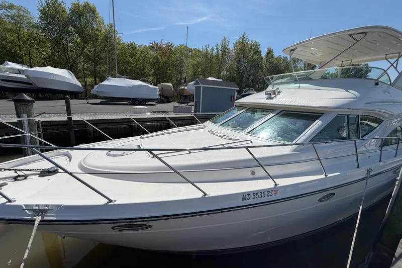 Slide: The Image of 2001 Maxum 4600 SCB Limited Edition yacht docked at marina under clear blue sky. - 7
