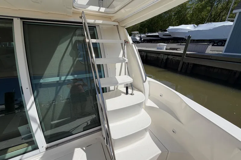 Slide: The Image of Staircase on 2001 Maxum 4600 SCB Limited Edition yacht, docked near water. - 8