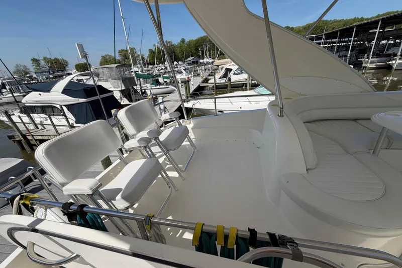 Slide: The Image of 2001 Maxum 4600 SCB Limited Edition yacht deck with seating at marina. - 9