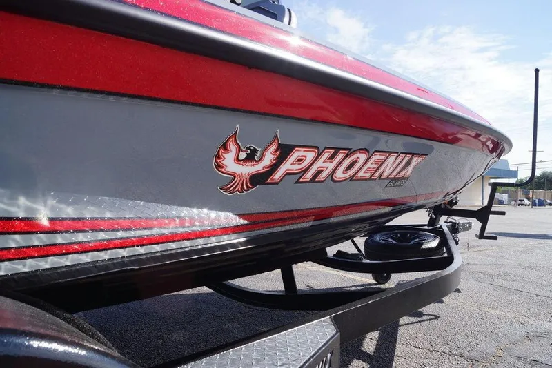 Slide: The Image of 2026 Phoenix 921 Elite X boat with red and silver detailing on a trailer. - 15