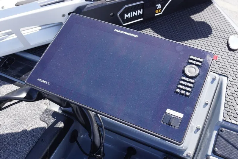 Slide: The Image of Control panel of a 2026 Phoenix 921 Elite X boat featuring Humminbird Xplore 12. - 18