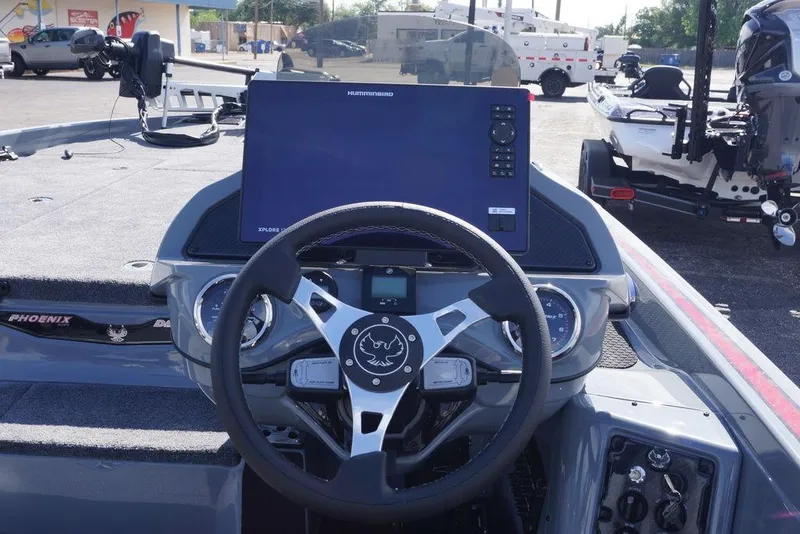 Slide: The Image of 2026 Phoenix 921 Elite X boat dashboard with steering wheel and navigation display. - 21