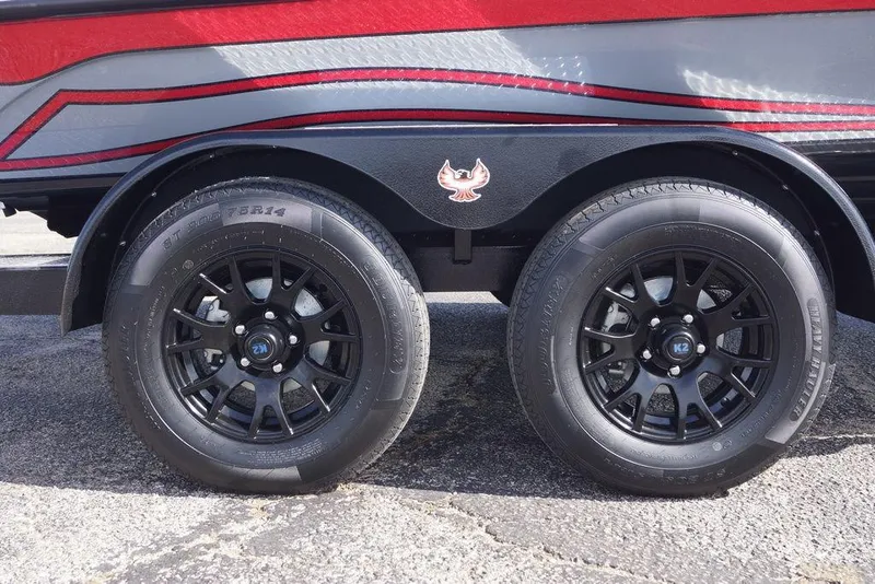 Slide: The Image of 2026 Phoenix 921 Elite X trailer with black K2 wheels and red-gray detailing. - 3