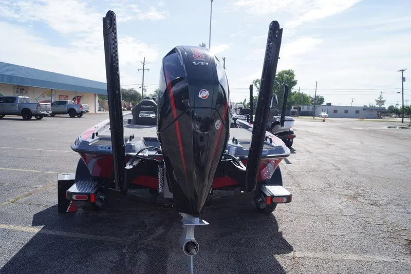 Slide: The Image of 2026 Phoenix 921 Elite X boat with powerful outboard motor in a parking lot. - 6