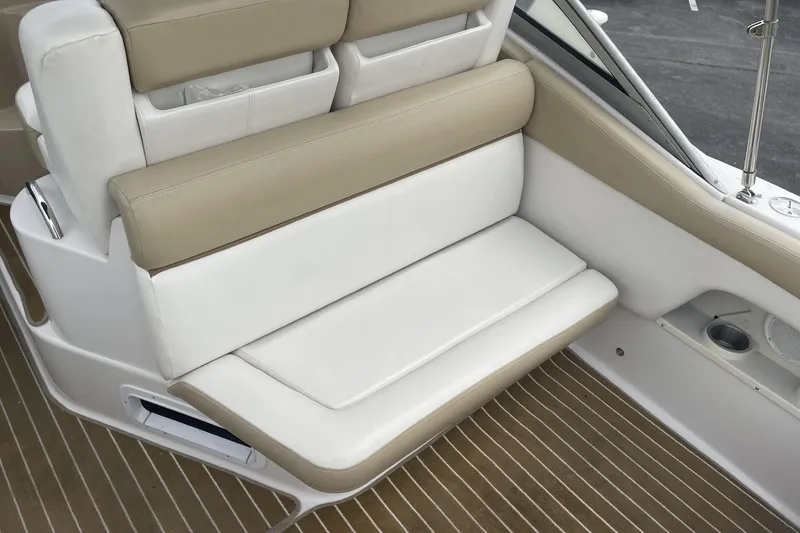 Slide: The Image of 2009 Four Winns V258 boat interior seating with beige and white upholstery. - 10