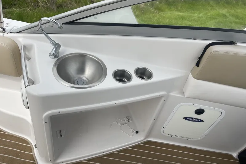Slide: The Image of 2009 Four Winns V258 boat interior with sink and storage compartment. - 16