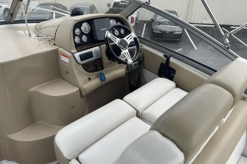 Slide: The Image of 2009 Four Winns V258 boat cockpit with steering wheel and control panel. - 18