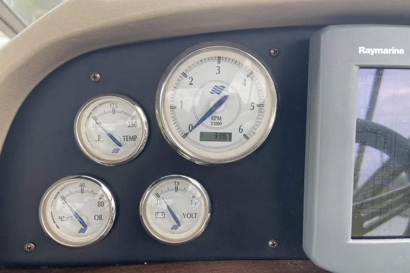 Slide: The Image of Dashboard gauges of a 2009 Four Winns V258 boat, showing RPM, temperature, oil, and voltage. - 21