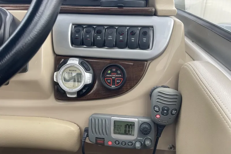 Slide: The Image of Control panel of a 2009 Four Winns V258 boat with radio and switches. - 24