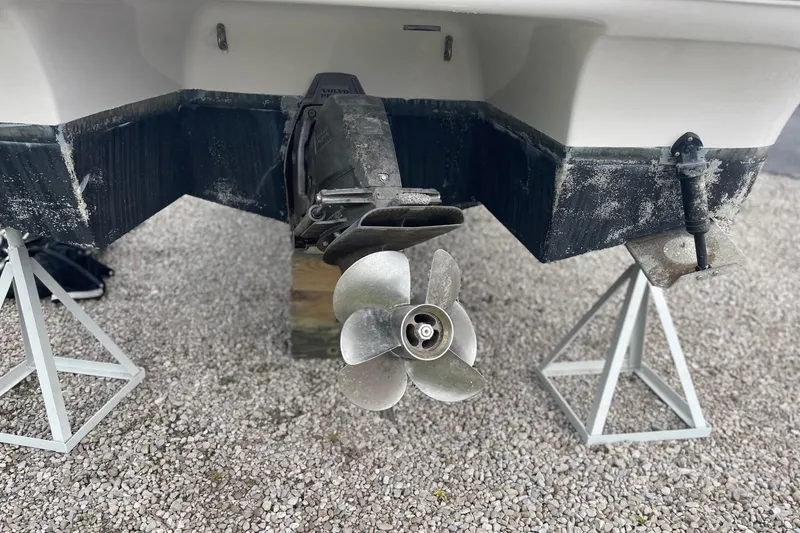 Slide: The Image of 2009 Four Winns V258 boat propeller and stern on gravel. - 3