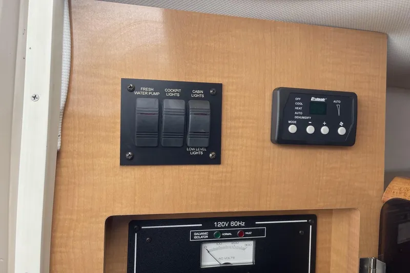 Slide: The Image of Control panel of a 2009 Four Winns V258 boat with switches and air conditioning controls. - 30