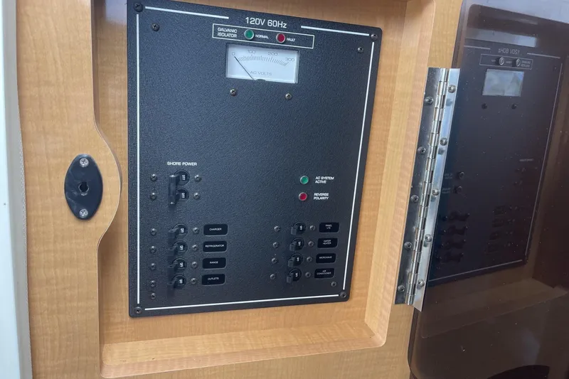 Slide: The Image of Electrical panel on a 2009 Four Winns V258 boat, featuring shore power controls. - 31