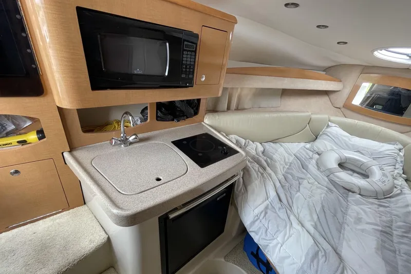 Slide: The Image of Interior of 2009 Four Winns V258 boat with kitchenette and cozy sleeping area. - 33