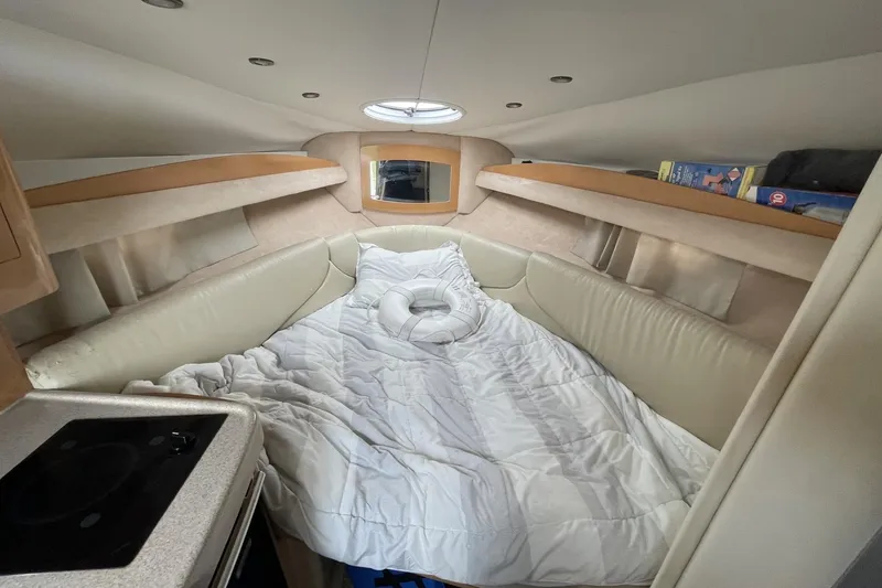 Slide: The Image of Interior cabin of 2009 Four Winns V258 boat with cozy bedding and storage shelves. - 34