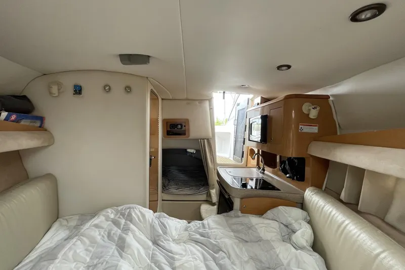 Slide: The Image of Interior of 2009 Four Winns V258 boat with bed, kitchenette, and cozy cabin space. - 35