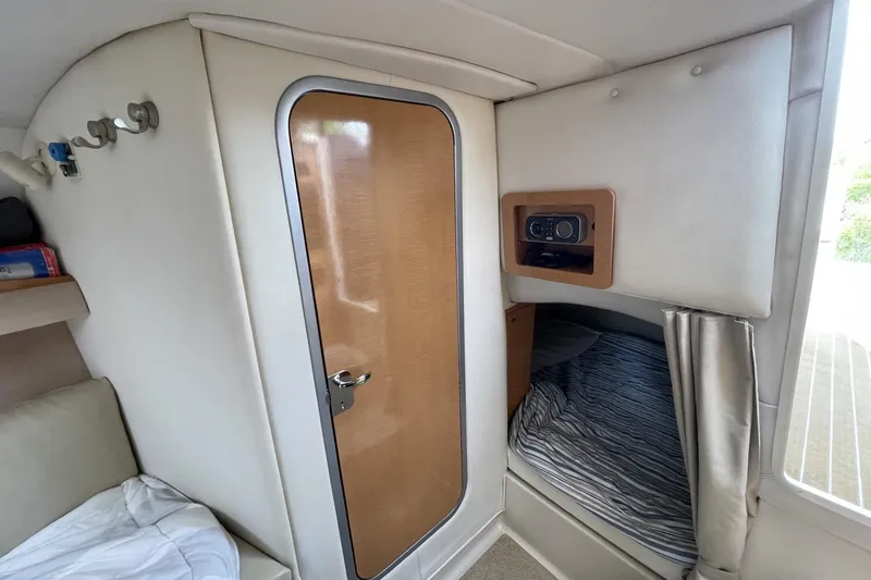 Slide: The Image of Interior cabin of 2009 Four Winns V258 boat with bed and wooden door. - 36