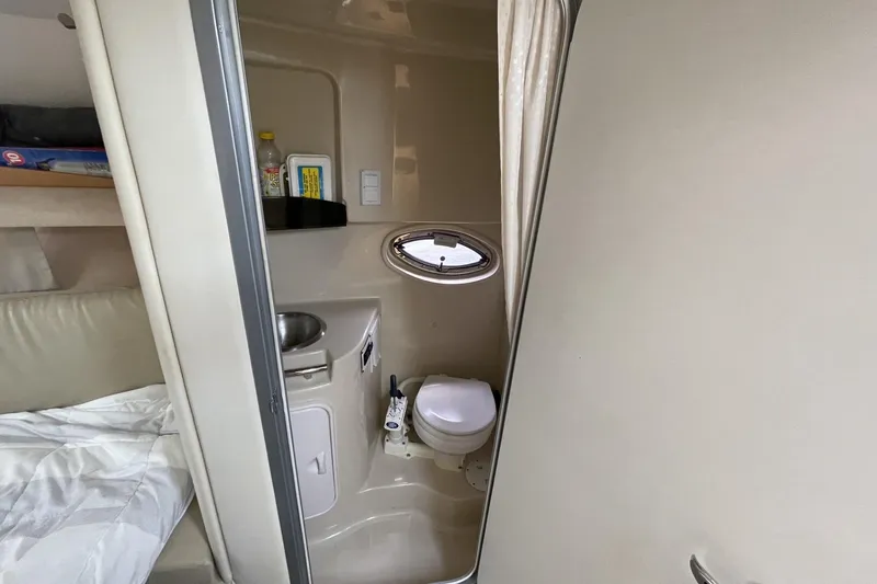 Slide: The Image of 2009 Four Winns V258 boat interior with compact bathroom and bed area. - 37
