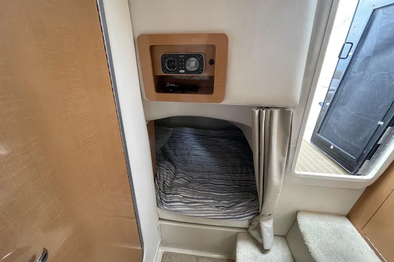 Slide: The Image of 2009 Four Winns V258 cabin interior with bed, stereo system, and steps. - 38