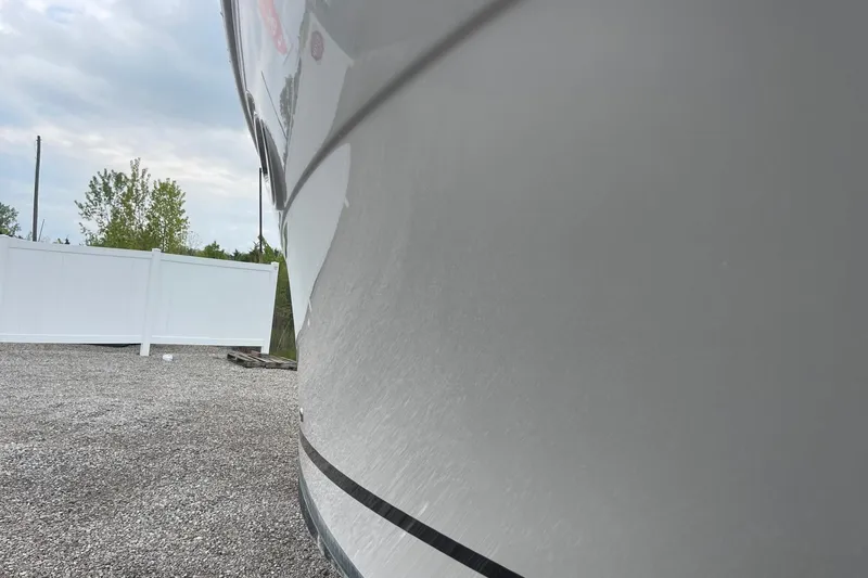 Slide: The Image of Side view of 2009 Four Winns V258 boat with white hull and black stripe. - 7