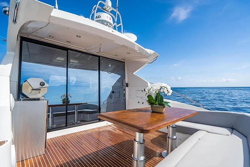 Slide: The Image of Luxury Beneteau Gran Turismo 2017 yacht deck with wooden table, ocean view, and blue sky. - 11