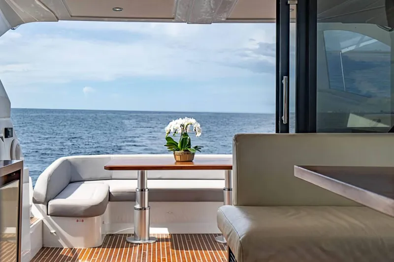 Slide: The Image of Interior view of 2017 Beneteau GRAN TURISMO yacht with ocean backdrop and elegant seating. - 19