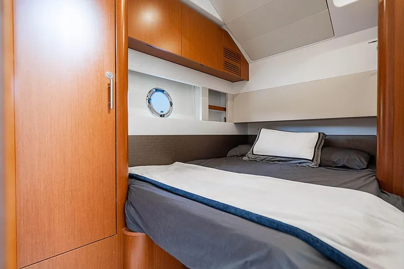 Slide: The Image of 2017 Beneteau Gran Turismo cabin interior with cozy bed and wooden furnishings. - 27