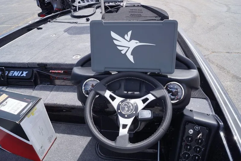 Slide: The Image of 2026 Phoenix 721 ZXL boat dashboard with steering wheel and control panel. - 10