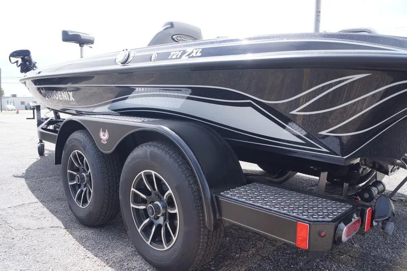 Slide: The Image of 2026 Phoenix 721 ZXL boat on a trailer, showcasing sleek design and dual wheels. - 11