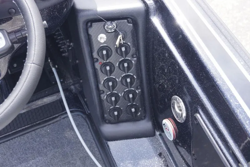 Slide: The Image of Control panel of a 2026 Phoenix 721 ZXL boat with multiple switches and steering wheel. - 15