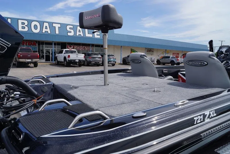Slide: The Image of 2026 Phoenix 721 ZXL boat displayed at dealership, showcasing spacious deck and seating. - 20
